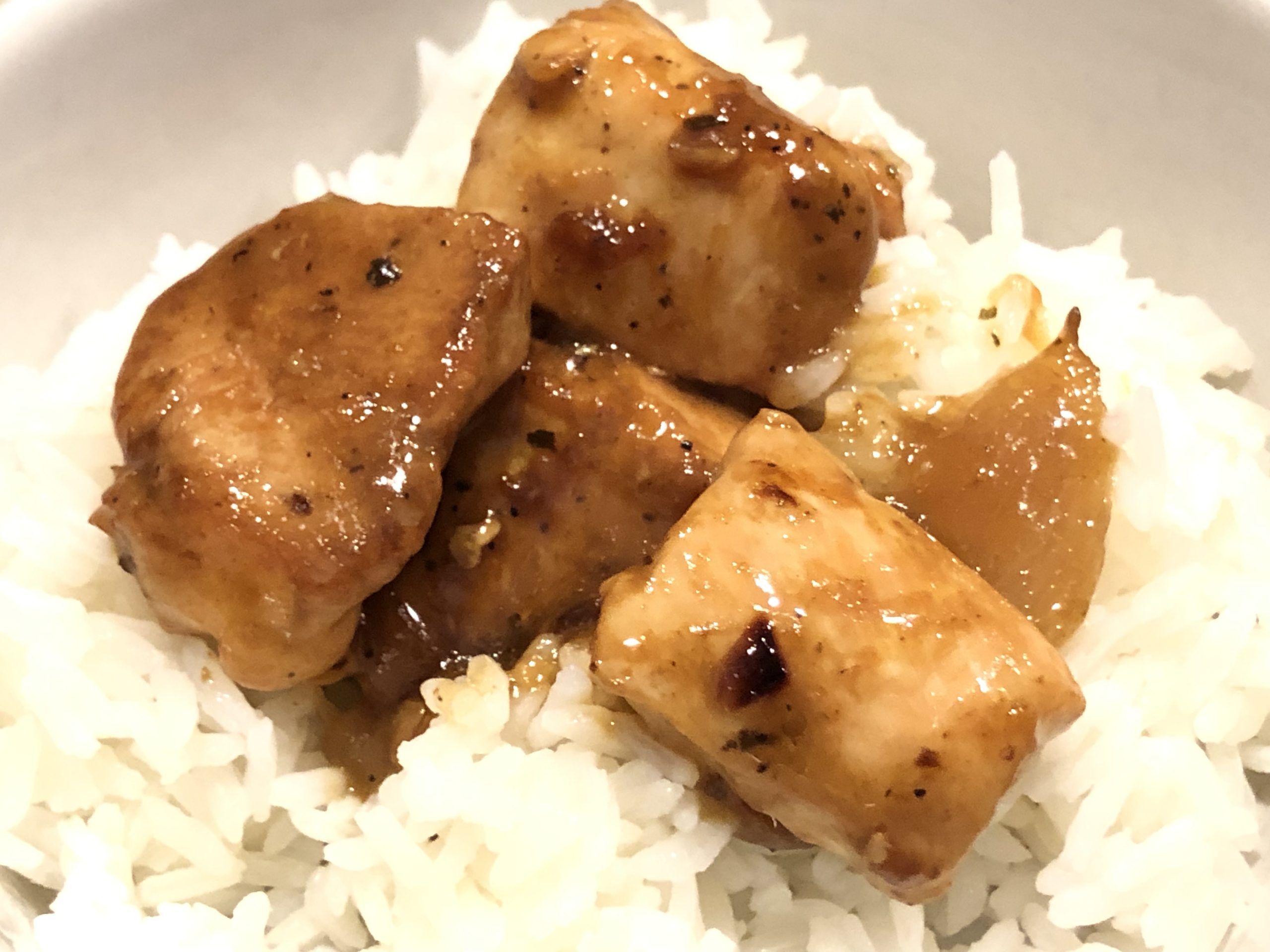 Easy Skillet Chicken with Onion and Garlic Sauce served on steamed Jasmine rice.